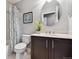 Bathroom featuring a vanity, toilet, and shower-tub with patterned curtain at 5656 S Sicily Ct, Aurora, CO 80015