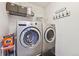 Laundry room with modern, stainless steel washer and dryer at 5656 S Sicily Ct, Aurora, CO 80015