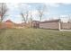 Large backyard featuring a manicured lawn, a tall wood fence, and a storage shed at 4180 S Elati St, Englewood, CO 80110