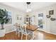 Bright dining area with hardwood floors, a modern light fixture, and a view of the backyard at 4180 S Elati St, Englewood, CO 80110