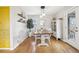 Dining room featuring hardwood floors, stylish lighting, and a decorative cabinet for storage at 4180 S Elati St, Englewood, CO 80110