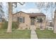 Charming single-story home with a well-maintained lawn and inviting front entrance adorned with a wreath at 4180 S Elati St, Englewood, CO 80110