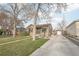 Charming single-Gathering home with mature trees, a well-manicured lawn, and a long driveway at 4180 S Elati St, Englewood, CO 80110