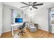 Modern home office with an adjustable desk, comfortable chair, and a large window for natural light at 4180 S Elati St, Englewood, CO 80110