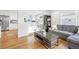 Open-concept living room with hardwood floors, a comfortable sofa, and a view into the kitchen at 4180 S Elati St, Englewood, CO 80110