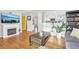 Bright living area with hardwood floors, a fireplace, and a view of the adjacent kitchen and dining area at 4180 S Elati St, Englewood, CO 80110