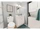 Bright bathroom features a white single sink vanity, stackable washer and dryer, and neutral wall color at 9195 E Lehigh Ave # 190, Denver, CO 80237