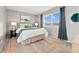 Serene bedroom with neutral colors, plush bedding, and bright natural light at 9195 E Lehigh Ave # 190, Denver, CO 80237