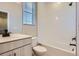 Clean bathroom featuring a bathtub, toilet, vanity with sink, and a window at 9657 Browns Peak Cir, Littleton, CO 80125