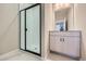 Modern bathroom with a walk-in shower and a light vanity at 9657 Browns Peak Cir, Littleton, CO 80125