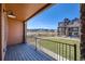 Private deck overlooking a landscaped yard and community amenities at 9657 Browns Peak Cir, Littleton, CO 80125