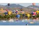 Hot air balloons over lake with boats and mountain backdrop at 9657 Browns Peak Cir, Littleton, CO 80125