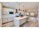 Open concept kitchen with island, stainless steel appliances & white cabinets at 9657 Browns Peak Cir, Littleton, CO 80125