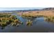 Aerial view of a serene lake with fall foliage at 9657 Browns Peak Cir, Littleton, CO 80125