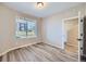 Bright and spacious room with wood-look flooring and large window at 9657 Browns Peak Cir, Littleton, CO 80125