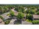 Aerial view of townhomes with private garages surrounded by mature trees and green lawns at 11704 Elk Head Range Rd, Littleton, CO 80127