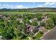 Scenic aerial view of homes surrounded by mature trees and mountain views at 11704 Elk Head Range Rd, Littleton, CO 80127