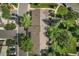 An aerial view of well-maintained townhomes surrounded by mature trees and lush green lawns at 11704 Elk Head Range Rd, Littleton, CO 80127