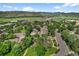 Aerial view of residential community with tree-lined streets and mountain views at 11704 Elk Head Range Rd, Littleton, CO 80127