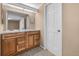 This bathroom features a wooden vanity with marble countertops and two mirrors at 11704 Elk Head Range Rd, Littleton, CO 80127