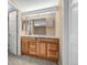 This bathroom features a wooden vanity with marble countertops and two mirrors at 11704 Elk Head Range Rd, Littleton, CO 80127