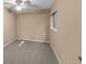 Cozy bedroom featuring neutral colored walls and carpet, window and ceiling fan at 11704 Elk Head Range Rd, Littleton, CO 80127