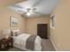 Cozy bedroom features a comfortable bed, dresser, nightstand, and a ceiling fan for optimal comfort at 11704 Elk Head Range Rd, Littleton, CO 80127