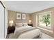 Comfortable bedroom featuring a large window, neutral tones, and cozy decor elements for a relaxing atmosphere at 11704 Elk Head Range Rd, Littleton, CO 80127