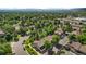 Aerial view of a home in a lush, green neighborhood with mature trees and well-maintained landscaping at 11704 Elk Head Range Rd, Littleton, CO 80127