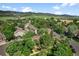 A beautiful aerial view of a neighborhood surrounded by mature trees with mountain views at 11704 Elk Head Range Rd, Littleton, CO 80127