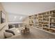 Open loft area featuring built-in bookshelves, neutral paint, and natural light from skylights at 11704 Elk Head Range Rd, Littleton, CO 80127