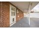 Covered back porch with brick wall, exterior door, and view of backyard at 3620 N Saint Paul St, Denver, CO 80205