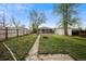 Well-sized backyard with lush green grass, a fire pit, and mature trees, creating a serene outdoor oasis at 3620 N Saint Paul St, Denver, CO 80205