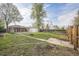 Spacious backyard featuring a fire pit and mature trees, perfect for outdoor entertaining and relaxation at 3620 N Saint Paul St, Denver, CO 80205