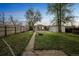 Lovely backyard with lush green grass, a fire pit, and mature trees, perfect for relaxing or entertaining at 3620 N Saint Paul St, Denver, CO 80205