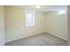 Small finished basement bedroom with neutral carpet and natural light from two windows at 3620 N Saint Paul St, Denver, CO 80205