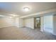 Spacious finished basement area with neutral carpet, lighting, and a view into an attached bathroom at 3620 N Saint Paul St, Denver, CO 80205