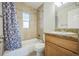 Cozy bathroom featuring tiled walls, a bathtub with shower, and a granite vanity at 3620 N Saint Paul St, Denver, CO 80205