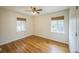 Cozy bedroom featuring hardwood floors, ceiling fan and natural light from the two windows at 3620 N Saint Paul St, Denver, CO 80205