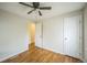 Comfortable bedroom featuring hardwood floors, a ceiling fan, a closet, and an entry door at 3620 N Saint Paul St, Denver, CO 80205