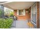 Cozy covered front porch featuring comfortable seating and classic brick architecture at 3620 N Saint Paul St, Denver, CO 80205