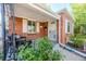 Inviting covered front porch with seating, a storm door, and well-kept landscaping at 3620 N Saint Paul St, Denver, CO 80205
