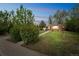 Beautifully landscaped front yard with mature trees leading to a classic brick home at 3620 N Saint Paul St, Denver, CO 80205