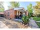 Well-maintained brick home with a cozy front porch and professionally landscaped garden beds at 3620 N Saint Paul St, Denver, CO 80205