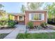 Attractive brick home with a covered porch, manicured lawn, and charming curb appeal at 3620 N Saint Paul St, Denver, CO 80205
