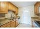 Spacious kitchen featuring granite countertops, wooden cabinets, and stainless steel sink at 3620 N Saint Paul St, Denver, CO 80205