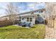A vibrant backyard with patio set, gas grill and lush green lawn, ideal for outdoor gatherings at 6276 Turnstone Pl, Castle Rock, CO 80104