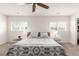 Bright bedroom features neutral tones, ceiling fan, and dual windows at 6276 Turnstone Pl, Castle Rock, CO 80104