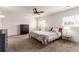 Serene bedroom with a ceiling fan, plush carpet, and a large dresser for ample storage at 6276 Turnstone Pl, Castle Rock, CO 80104