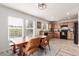 Eat-in kitchen with a rustic dining table beneath bright windows and natural wood cabinets at 6276 Turnstone Pl, Castle Rock, CO 80104